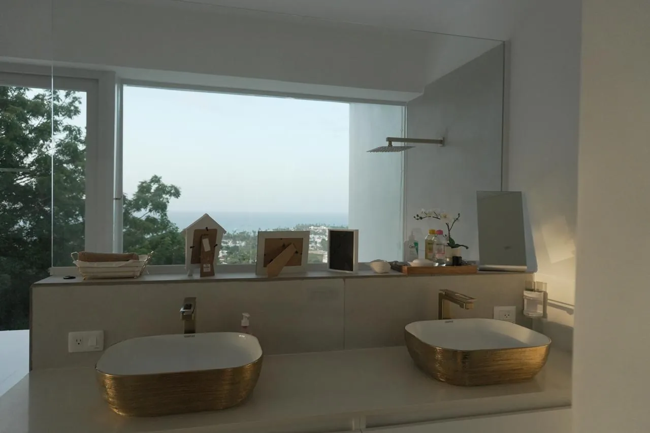 Gold designer bathroom with ocean view