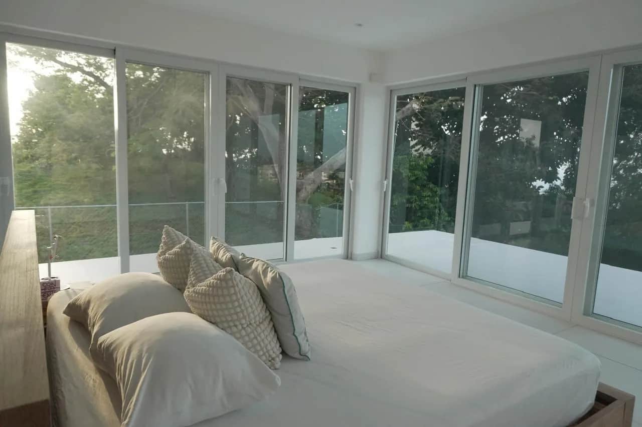 Bedroom with glass front nature view